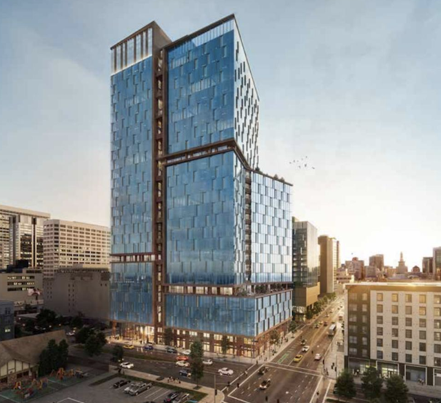 A modern high-rise building with reflective glass panels, situated on a bustling urban street at sunset.